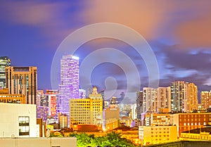 SUnset over Miami Florida skyline with illuminated modern buildings