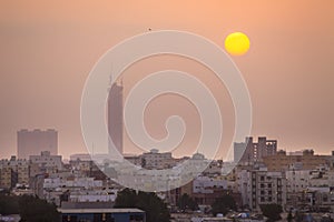 Sunset over modern office buildings in business district center of Jeddah Saudi Arabia. Skyline view of cityscape with sunlight an