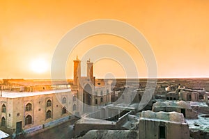 Sunset over mosque of Ghoortan citadell by village of Varzaneh -