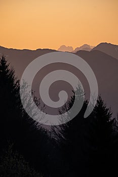 Sunset over mountains Mangart, Kanin in Julian Alps in spring