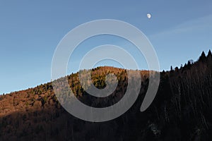 Sunset over the mountains and the moon. Carpathian. Ukraine