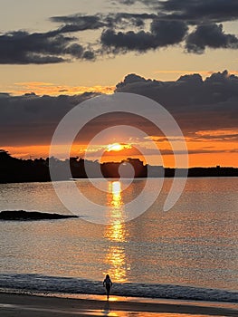 A sunset over the ocean with clouds