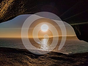 Sunset Over Ocean Framed by Remarkable Rocks