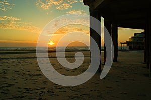 Sunset over the ocean with pier in blankenberge