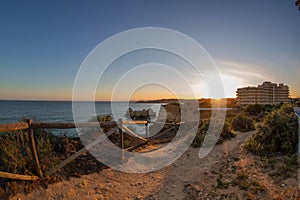 Sunset over the ocean and Praia de Vao beach in Portimao, Algarve, Portugal