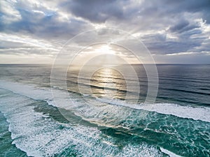 Sunset over ocean waves.