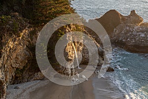 Sunset over the Pacific Ocean and McWay Falls in Big Sur, California