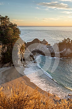 Sunset over the Pacific Ocean and McWay Falls in Big Sur, California