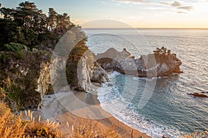 Sunset over the Pacific Ocean and McWay Falls in Big Sur, California