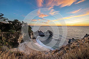 Sunset over the Pacific Ocean and McWay Falls in Big Sur, California