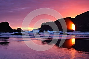 Sunset over the Pacific through sea arches, Olympic National Park, Washington, USA