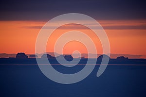 Sunset over pack ice with icebergs, East Greenland