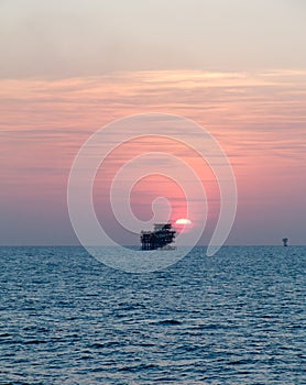 Sunset over Persian Gulf's oil field