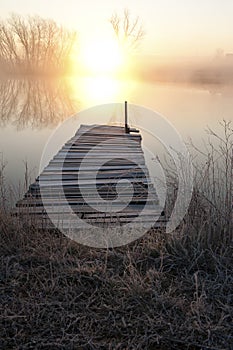 Sunset over pier on lake