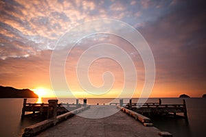 Sunset over pier and sea