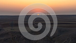 Sunset over plowed farm fields