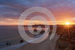 Sunset over the Praia do Amado on Algarve coast, Portugal. Long exposure shot