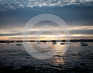 Sunset over river estuary west mersea essex seafront coast boats