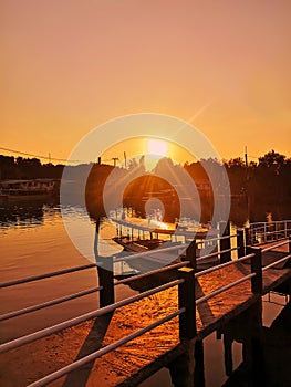 Sunset over river port with boats
