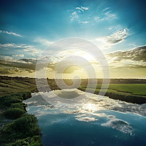 Sunset over river with reflections