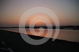 Sunset over the river rotte and waterstorage of the Eendragtspolder in Zevenhuizen, Netherlands
