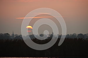 Sunset over the river Rotte in Zevenhuizen with windmills of the Molenviergang