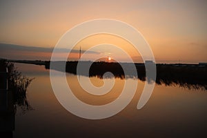 Sunset over the river Rotte in Zevenhuizen with windmills of the Molenviergang