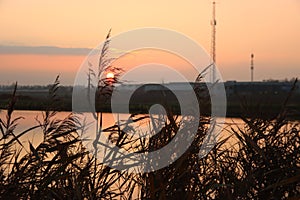 Sunset over the river Rotte in Zevenhuizen with windmills of the Molenviergang