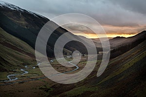 Sunset over road and the river of Moffat Water