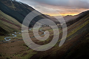 Sunset over road and the river of Moffat Water