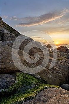 Sunset over a rock formation on the coast