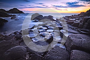 Sunset over rocks formation Giants Causeway, County Antrim, Northern Ireland, UK