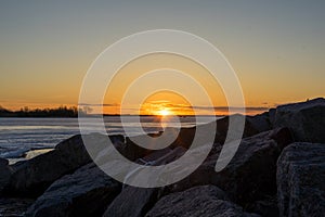 Sunset over rocks and water