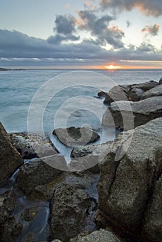 Sunset over rocky beach