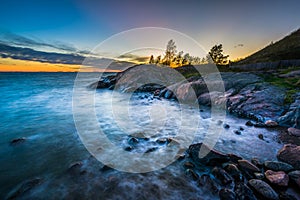 Sunset over rocky coast on Suomenlinna, in Helsinki, Finland.