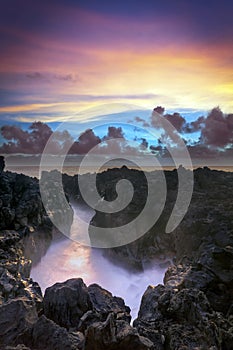 Sunset over rocky coastline