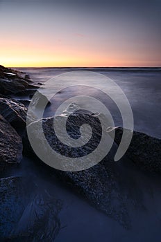 Sunset over rocky coastline