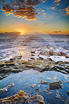 Sunset over rocky coastline