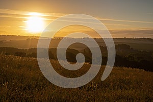 Sunset over the rolling hills in Elkenrade in the of south Limburg in the Netherlands with a spectacular view over the fields