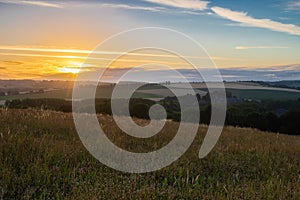 Sunset over the rolling hills in Elkenrade in the of south Limburg in the Netherlands with a spectacular view over the fields