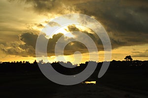 Sunset over rural landscape with dramatic clouds