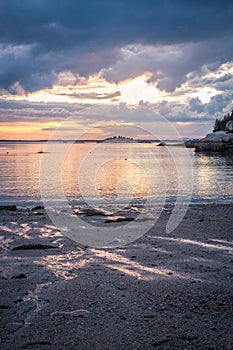 Sunset over Sand Beach in Stonington, Maine.