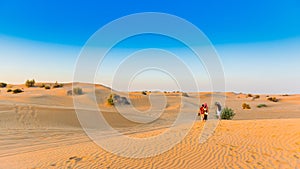 Sunset over sand dunes in Dubai Desert Conservation Reserve, United Arab Emirates. Copy space for text