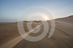 Sunset over sand dunes of Empty Quarter desert