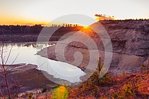 Sunset over the sand rock and lake landscape