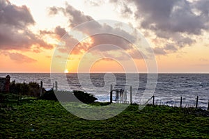 Sunset over sea from a cliff top view