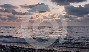 Sunset over the sea. Deep blue cumulus clouds