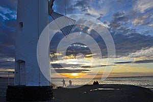 Sunset over the sea with lighthouse