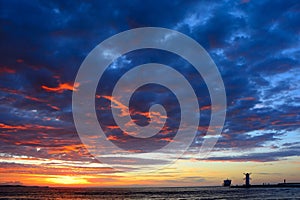 Sunset over the sea with lighthouse