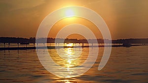 Sunset over the sea. Pier on the foreground in